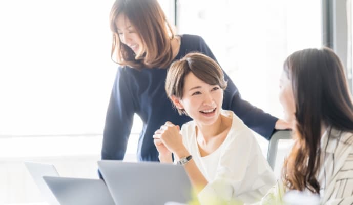 オフィスで会話している3人の女性