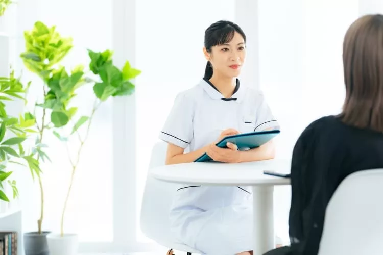 患者と会話する医療従事者の女性